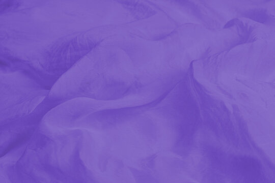 Soft smooth purple silk fabric background. Fabric texture.