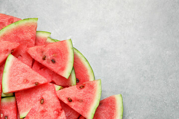 Slices of tasty ripe watermelon on light grey table, flat lay. Space for text