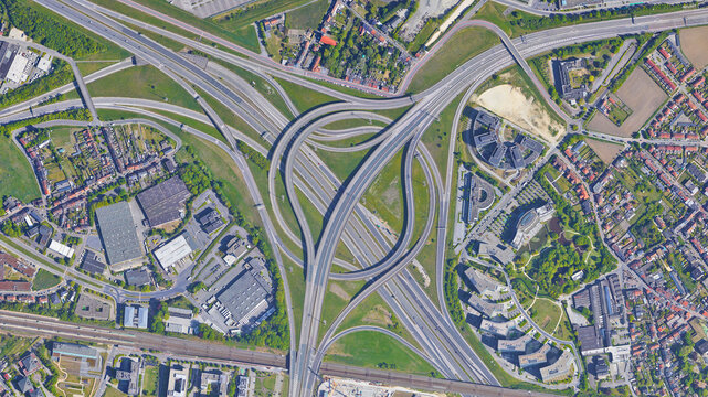 Raod, highway, flyover road junction - spaghetti and roundabout looking down aerial view from above, bird’s eye view expressway and intersection landscape, Zaventem, Flemish Brabant, Belgium

