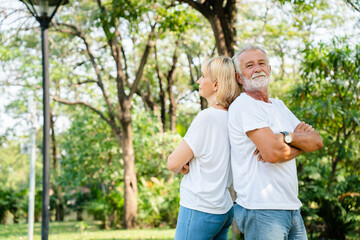 Fototapeta premium Senior Caucasian couple hugging in park. Family with a happy smile feels relaxed with nature in the morning. Or in the evening. Enter elderly society And retire from work. Concept health insurance
