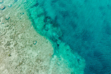 Drone abstract of coral reefs in ocean off coast of Okinawa