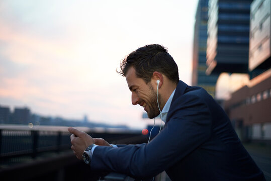 Business man at dawn in the city in a call on his mobile
