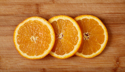 sliced orange on wooden background