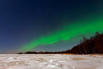 Aurora borealis green-purple on a clear winter night