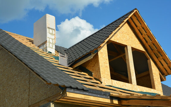 The Construction Of A Metal Roof Over An Attic With Installation Of A Waterproofing Flashing In A Problem Area, Roofing Valley. Chimney And Roofing Construction And Tiling.