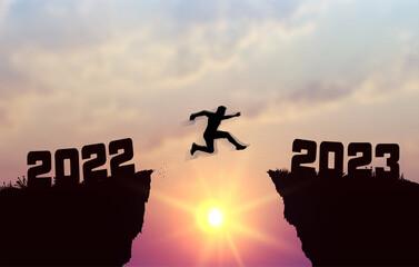 A young silhouette man jump between 2022 and 2023 years over the sun and through on the gap of hill evening sky. Business concept. Welcome Happy New Year 2023. Vector illustration.