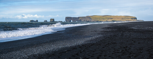Picturesque autumn Dyrholaey Cape and  rock formations view from Reynisfjara ocean black volcanic...