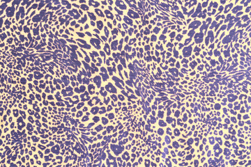 Colored leopard skin print on a mass-produced kani. Blue and beige color. Abstract drawing, background.