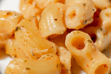 Spaghetti in spices and sauce close-up. Italian pasta. Food background.