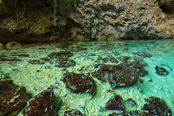 Three eyes cave in Santo Domingo, los Tres Ojos national park, Dominican Republic. Scenic view of limestone cave and crystal clear azure water of underground lake, nature landscape, travel background