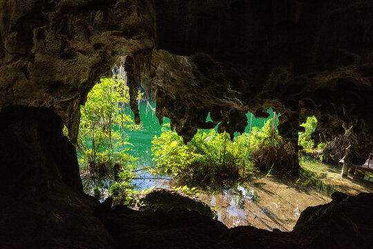 Three eyes cave in Santo Domingo, los Tres Ojos national park, Dominican Republic. Scenic view of limestone cave, beautiful lake and tropical plants, nature landscape, outdoor travel background