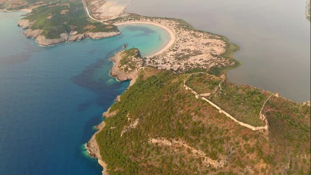 4k drone flying over footage (Ultra High Definition) of Voidokilia Beach and Old Navarino Castle. Morning seascpae of Ionian sea. Wonderful outdoor scene of Peloponnese peninsula, Greece, Europe.