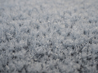 Obraz premium Snowflakes, snow crystals on the car roof. Freeze, frost, macro