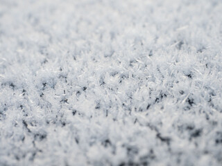 Snowflakes, snow crystals on the car roof. Freeze, frost, macro
