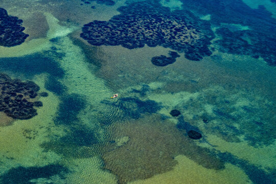 Aerial view of single female swimmer in the sea, Ayvalik, Turkey.