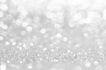Abstract bokeh white,light grey,sliver colors de focused circular background.Night light season greeting elegance backdrop or artwork design for newyear,christmas sparkling glittering or special day.