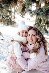 A little daughter and mother gently hug, kiss, showing love and expressing affection.Happy family, the pleasure of being a mom, congratulations on Mother's Day, the concept of a sweet moment together
