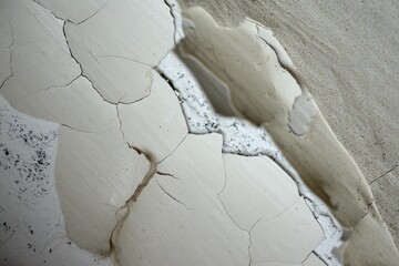 Old cracked paint on the wall. Falls off in chunks