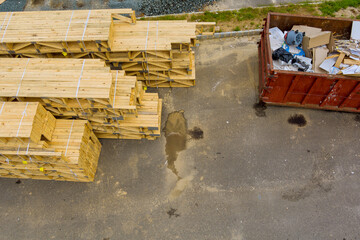 Stacked of lumber at materials wood rafters for roof in construction site for building a house