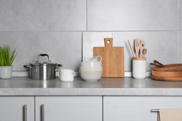 Cooking utensils and other kitchenware on grey countertop