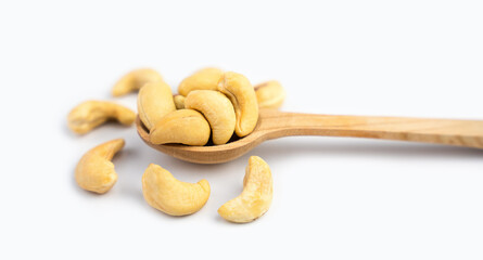Tasty cashew nuts in wooden spoon isolated on white background. Close-up. Banner. Selective focus.