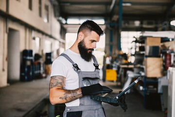 An industry worker using laptop for diagnostic a problem.