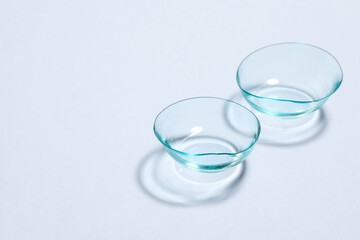 Pair of contact lenses on white background, space for text