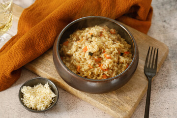 Italian Food: Risotto with vegetables on wooden background. Rustic style
