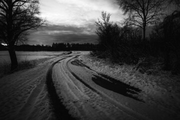 rarely used dirt road in Latvia countryside, slippery, dangerous winding country road