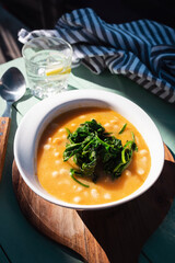 White beans with spinach. Legumes and vegetables. Healthy dish with vegan protein. Plant based food.