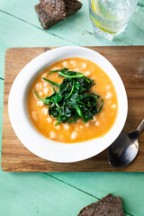 White beans with spinach. Legumes and vegetables. Healthy dish with vegan protein. Plant based food.