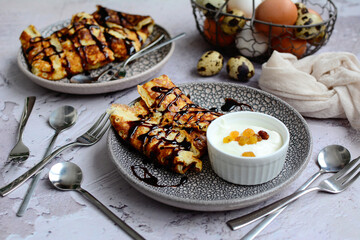 Pancakes decorated with chocolate syrup on plates. Closeup