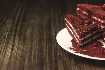 Cake with cranberries and cream on a wooden background.