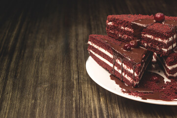 Cake with cranberries and cream on a wooden background.