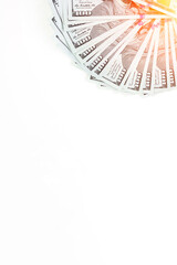 Fanned arrangement of American 100 dollar bills. American 100 dollar banknotes made of paper placed on white background.