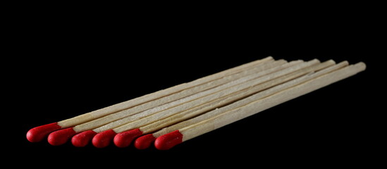 Fire matches pile isolated on black