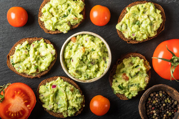 Sandwiches with guacamole sauce on a black background. Healthy Vegan, Vegetables food.