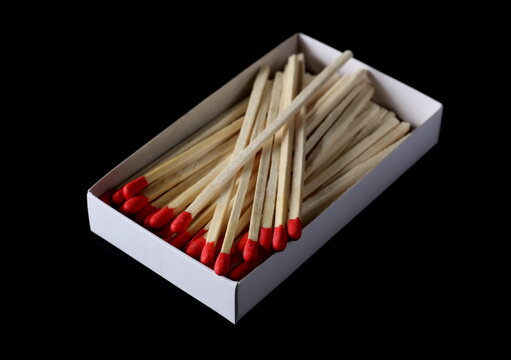 Fire matches pile with carton box isolated on black