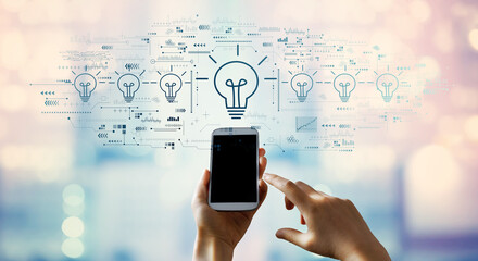 Idea light bulb theme with person using a smartphone