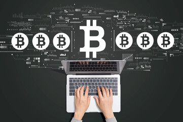 Bitcoin theme with person using a laptop computer