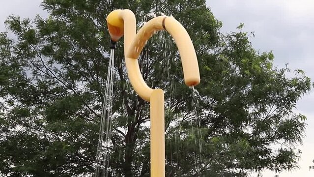 Splash pad in local public park. Fountain on a summer day
