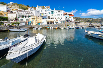 Fototapeta na wymiar Fishing boats moored at the colorful port of Sant’Angelo d’Ischia, Italy