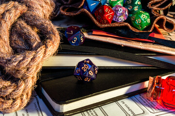 Close-up of a purple d20 on a black note-book