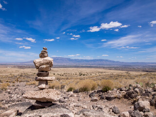 Fototapeta na wymiar Rock sculpture in New Mexican desert with a Blue Sky and Wispy Clouds