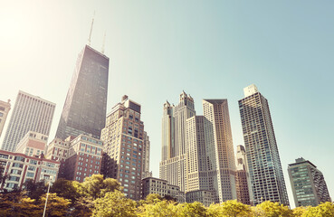 Retro toned picture of Chicago skyline against the sun, USA.