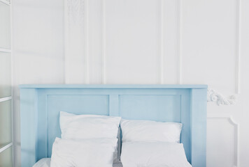Bedroom with blue bed white pillows