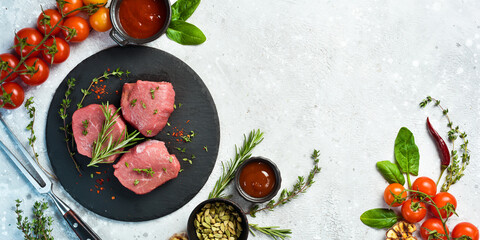 Raw veal medallions. Veal tenderloin is ready for cooking. Meat. On a stone background.