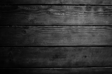Black charred wooden background. Wood texture. Top view. Free space for your text.