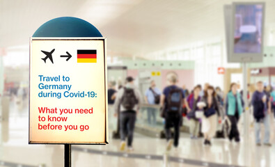a signal inside an airport that warns about what to know before flying to Germany during the Covid-19 pandemic
