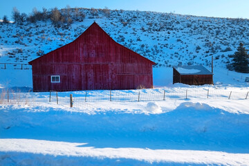 Red Barn in the Snow in Winter on Farm